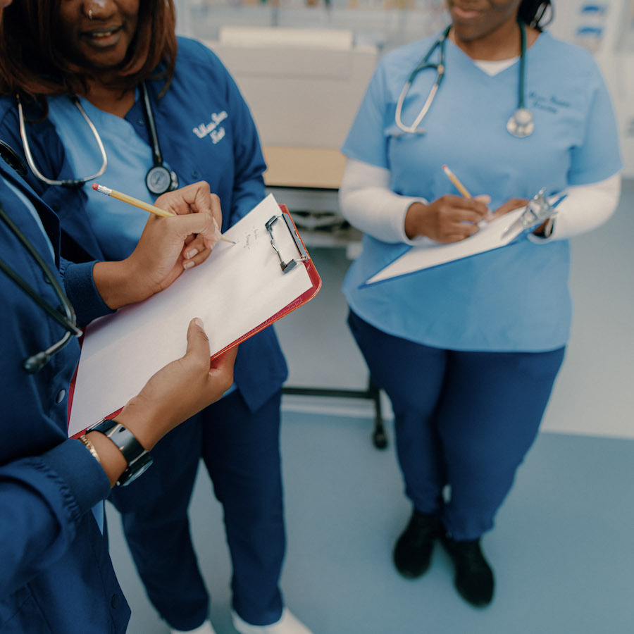 Nursing students on clipboard