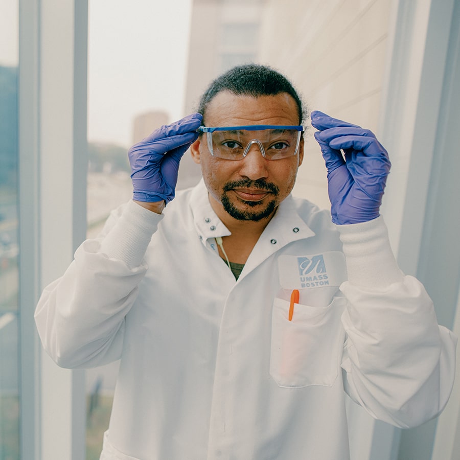 Grad student with goggles and labcoat poses in ISC