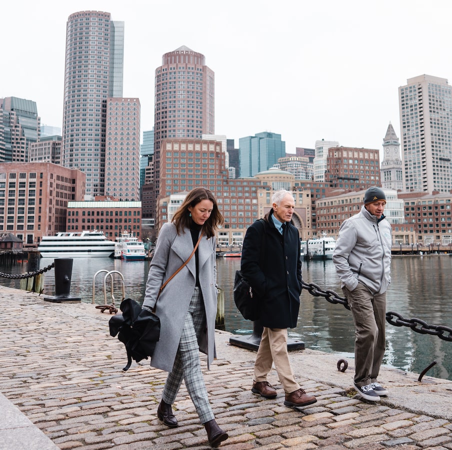 Students walking in Boston by water