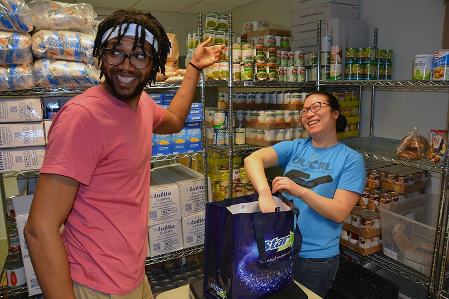 Two student work at Food Pantry U-Access.