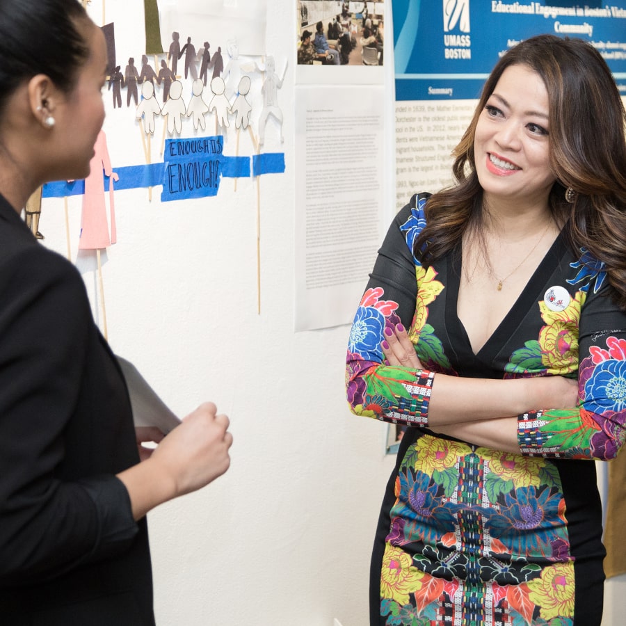 Professor Shirley Tang talks to student.