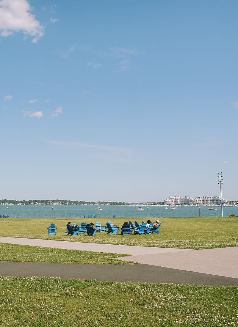 Blue chairs on the campus center lawn.