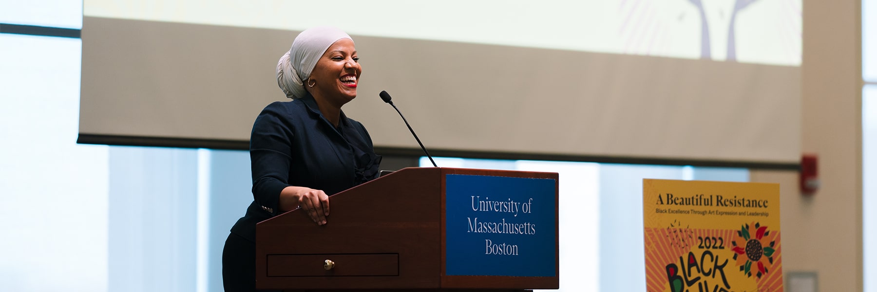 Woman speaks at podium for Black Lives Matter day.