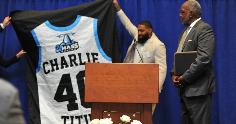 Charlie Titus and the unveiled banner with his retired number 40
