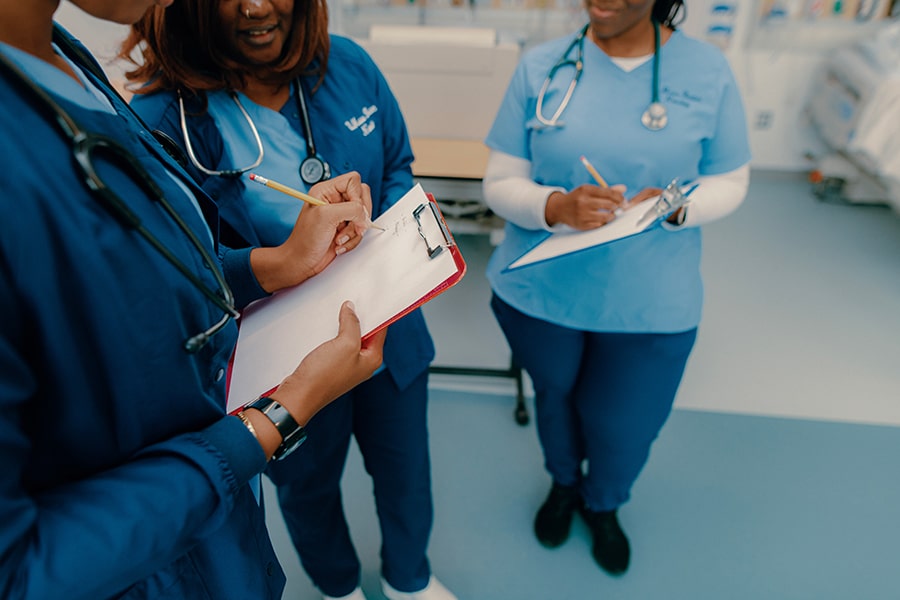 closeup of nursing students with clipboard in training