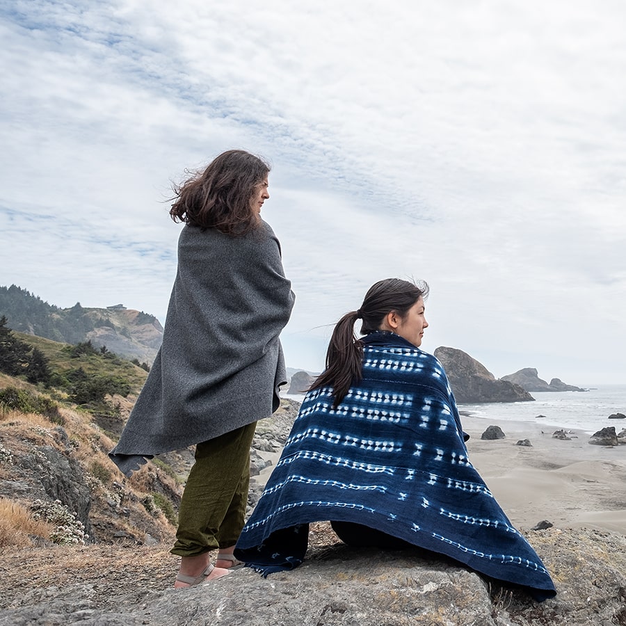 women in traditional shawls looking out towards ocean Windy, secluded beach, Samuel Boardman Corridor, Oregon Coast, Oregon, USA