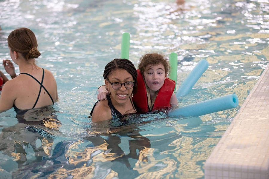 Camp Shriver kid and counselor in pool