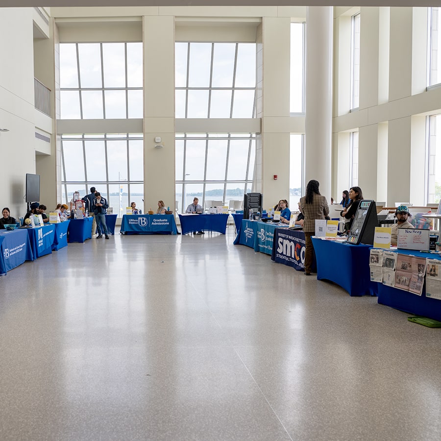 Campus Center Main lobby with vendor tables draped with blue cloths.