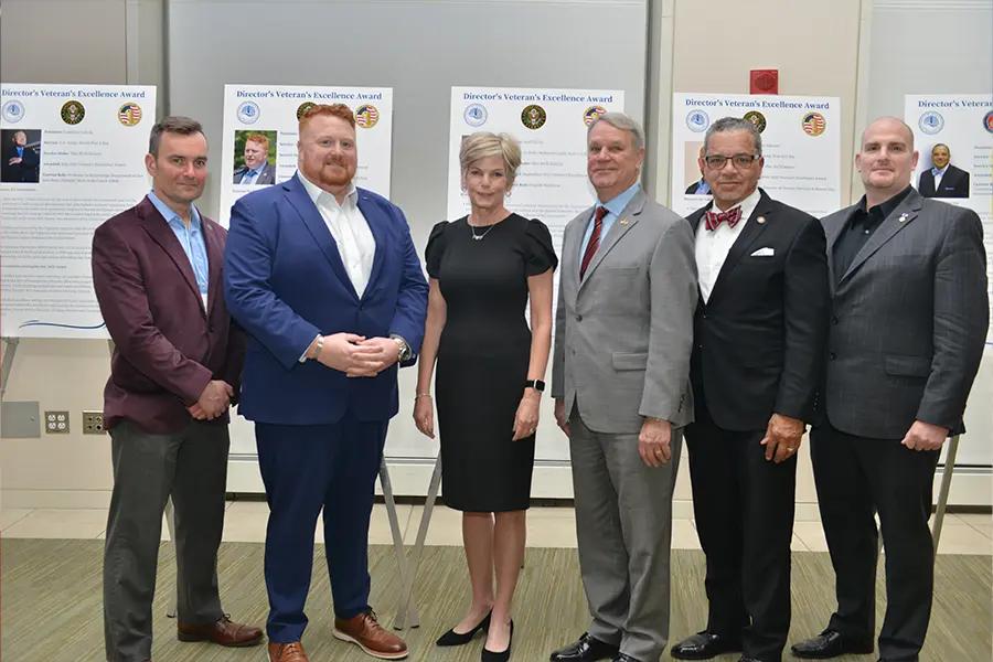 Group of veterans stand for the Honor a Veteran award.