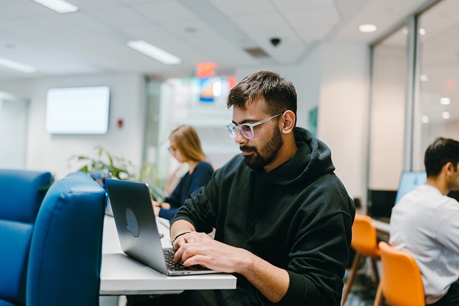 student on laptop in One Stop office